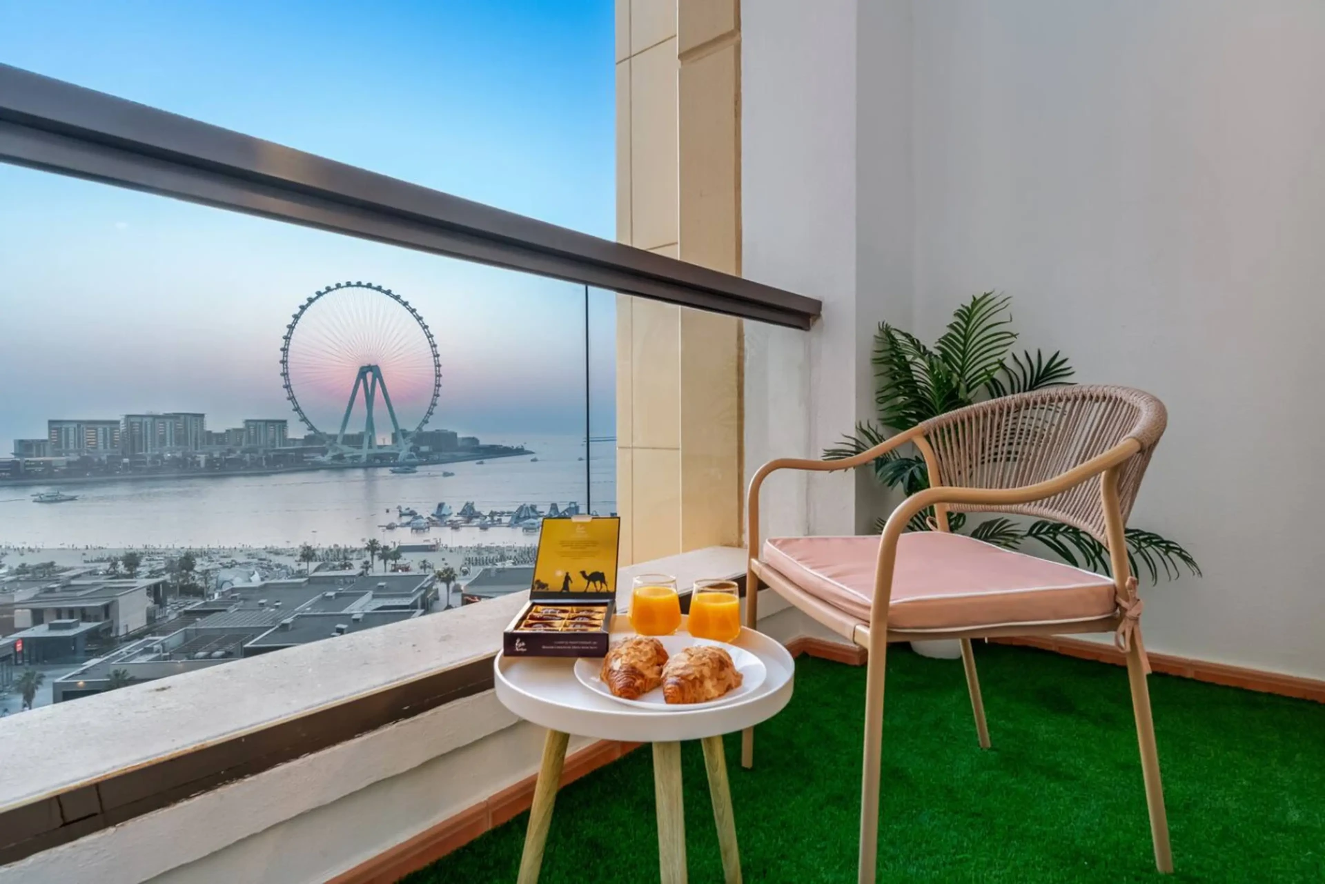 Dubai balcony sunset overlooking Ain Dubai and JBR beach